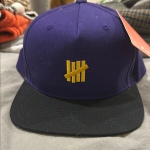 Undefeated Purple and Black Cap with Yellow Logo SnapBack